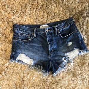 Free people mid rise button up distressed shorts